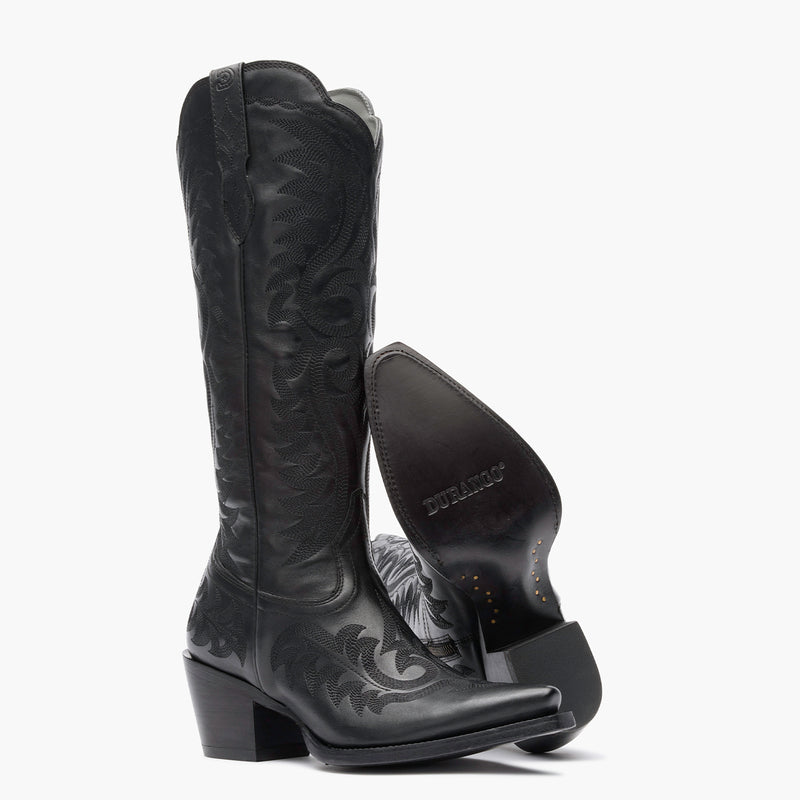 Front view of a pair of Durango black cowgirl boots with black stitching and black leather sole.