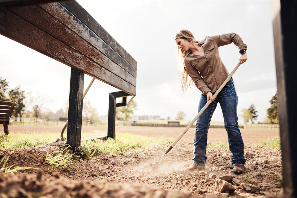 Woman working the dirt at the ranch.