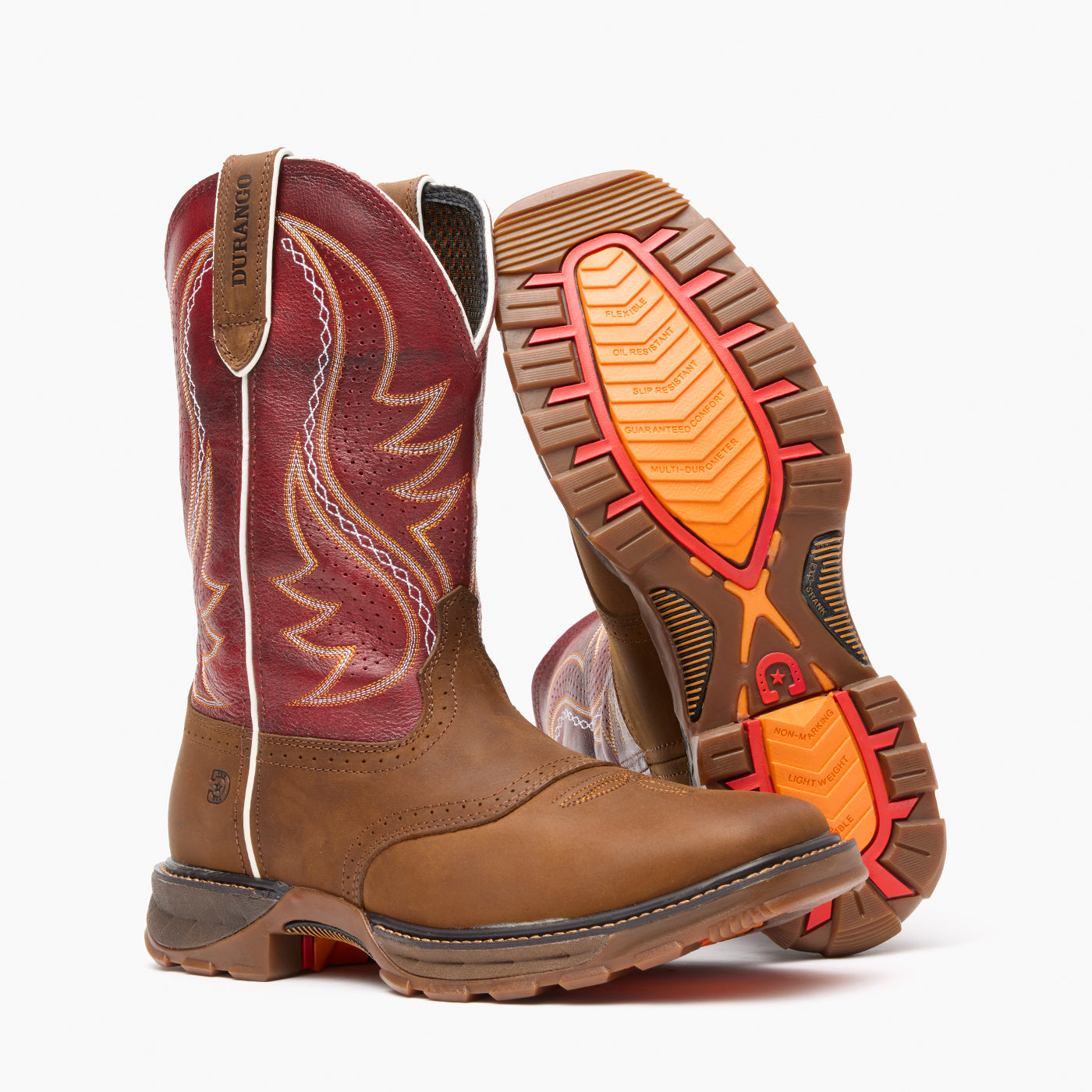 Pair of brown and red cowboy boots with orange soles on a white background
