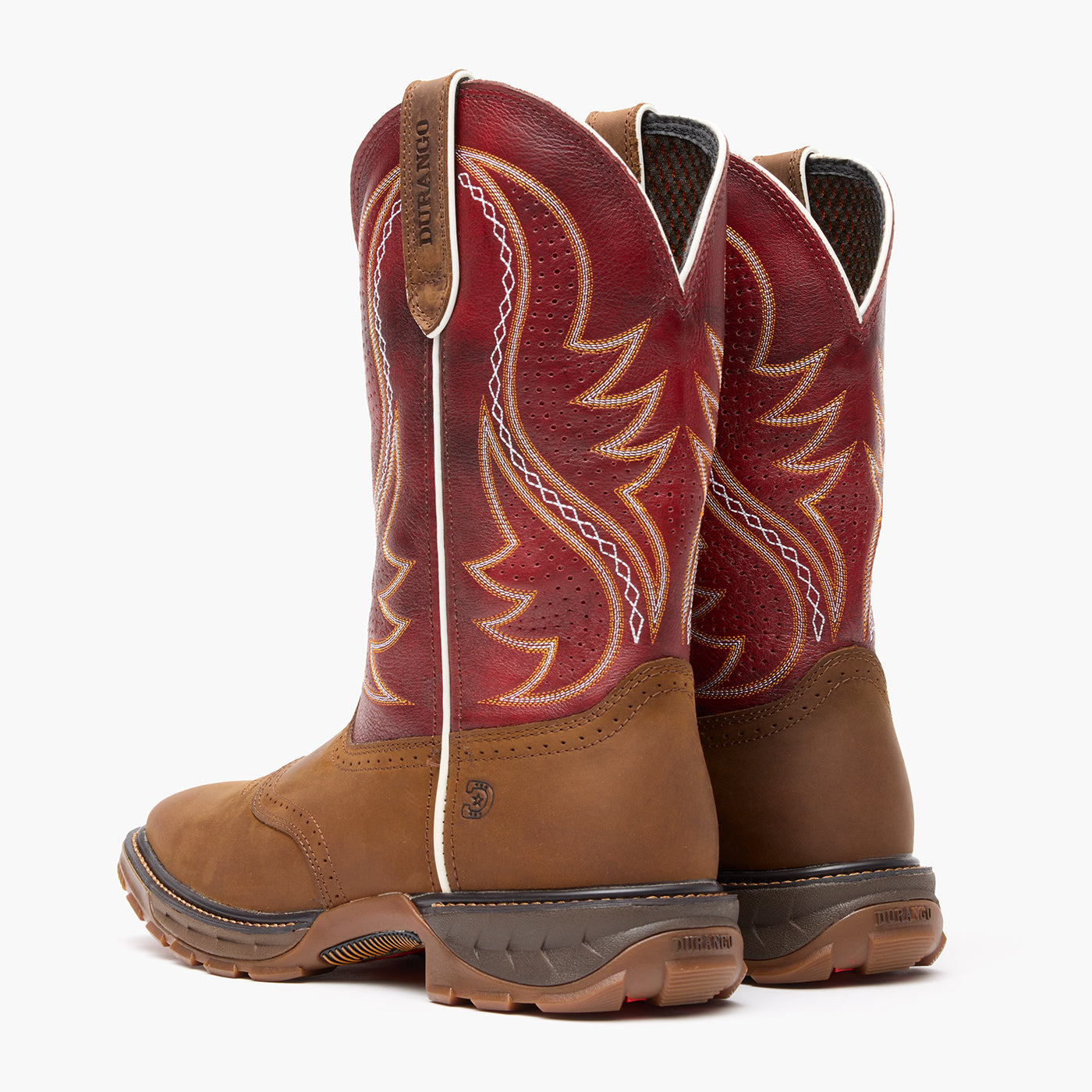 Pair of brown and red cowboy boots with intricate designs on a white background