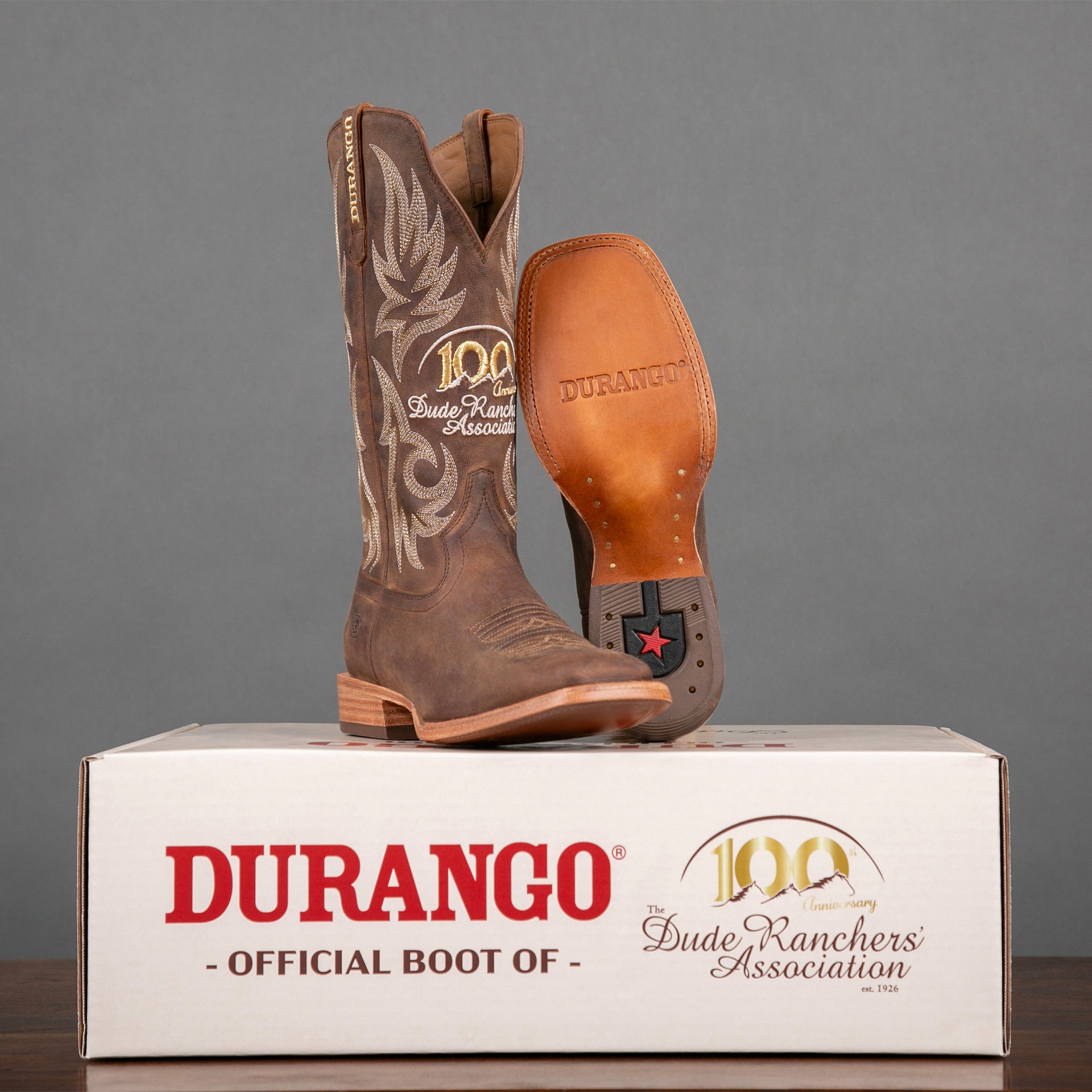 Brown Durango 100th Anniversary Dude Ranchers' Association cowboy boots on a custom branded box