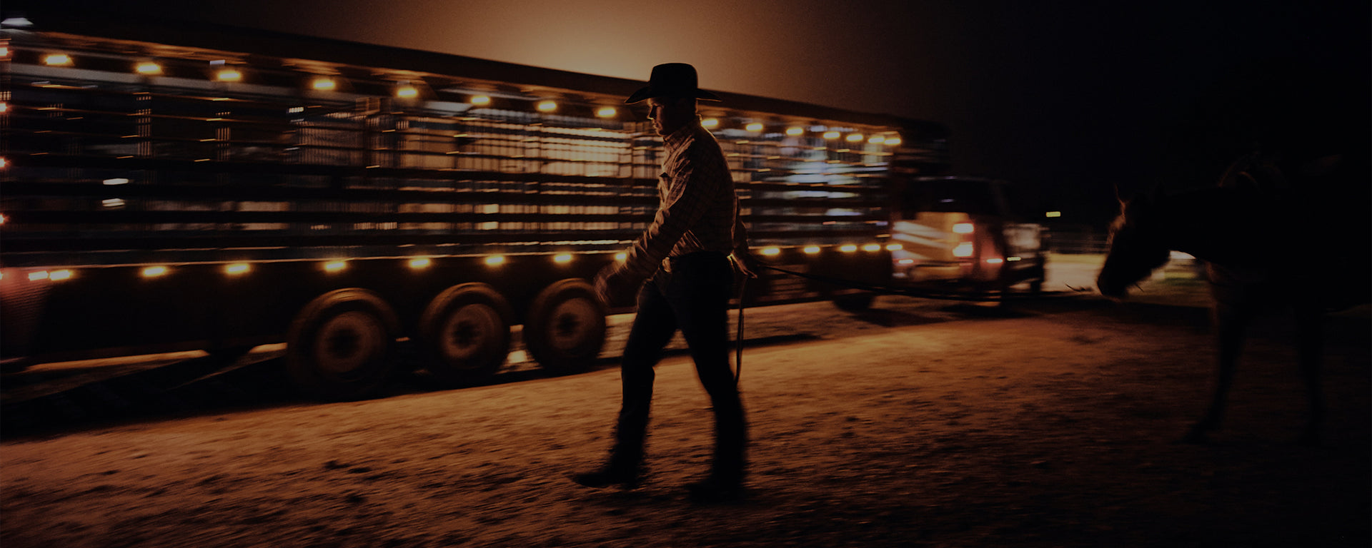 Team Durango cowboy leading horse