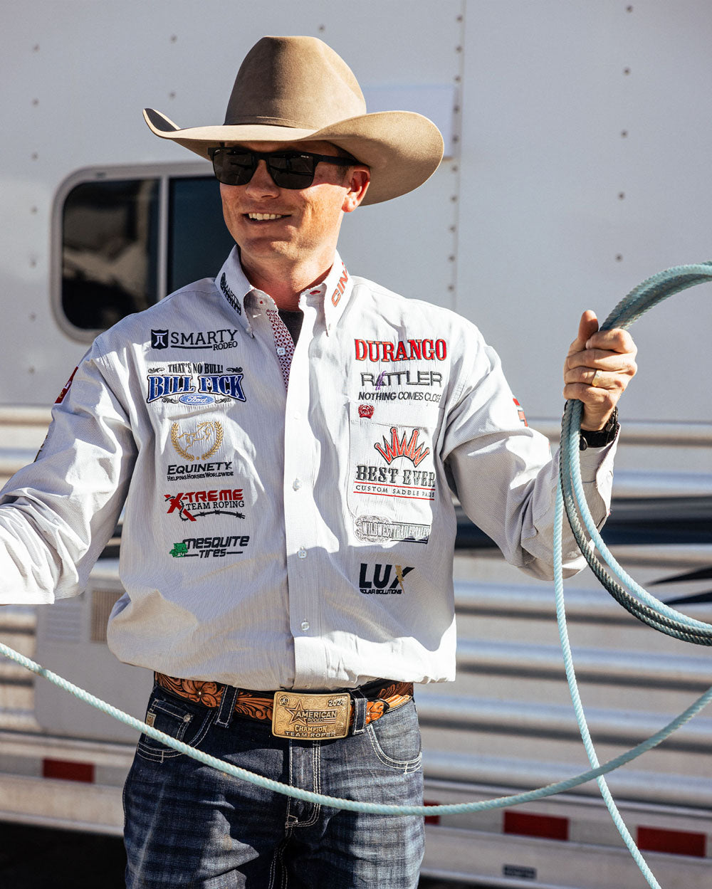 Team Durango Team Roper, Hunter Koch holding a rope in front of a horse trailer.